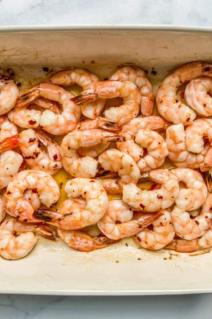 Baked shrimp in a baking dish.