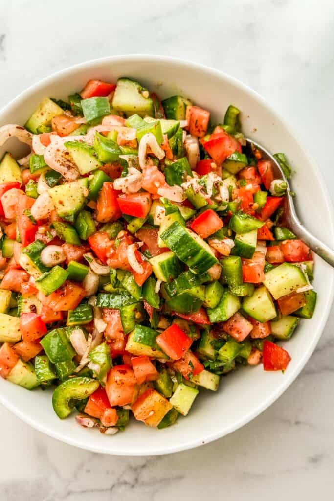 An overhead shot of a chopped Turkish salad in a white serving bowl.