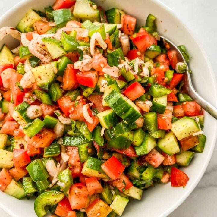 An overhead shot of a chopped Turkish salad in a white serving bowl.