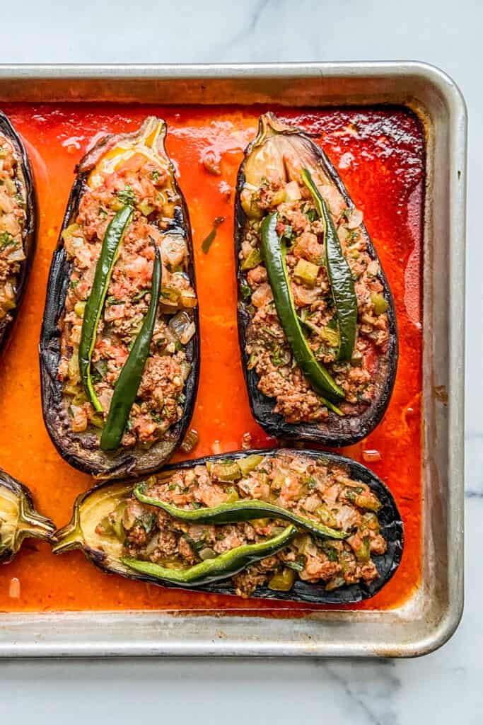 Turkish stuffed eggplants on a baking sheet, after coming out of the oven.