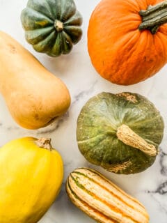 Types of winter squash on a marble background.