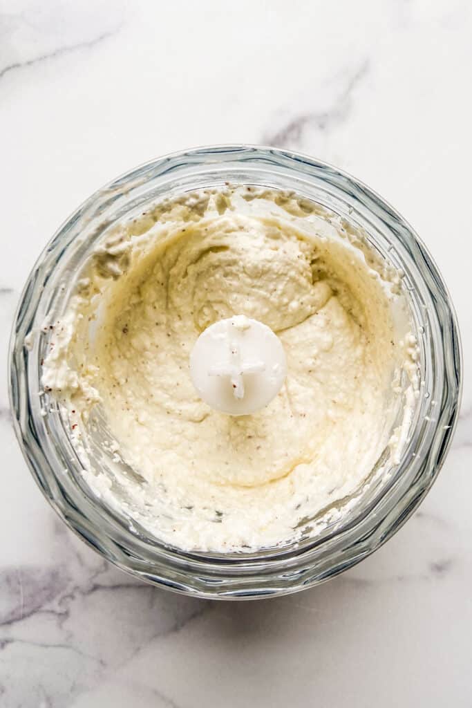 Blended feta dip in a food processor.