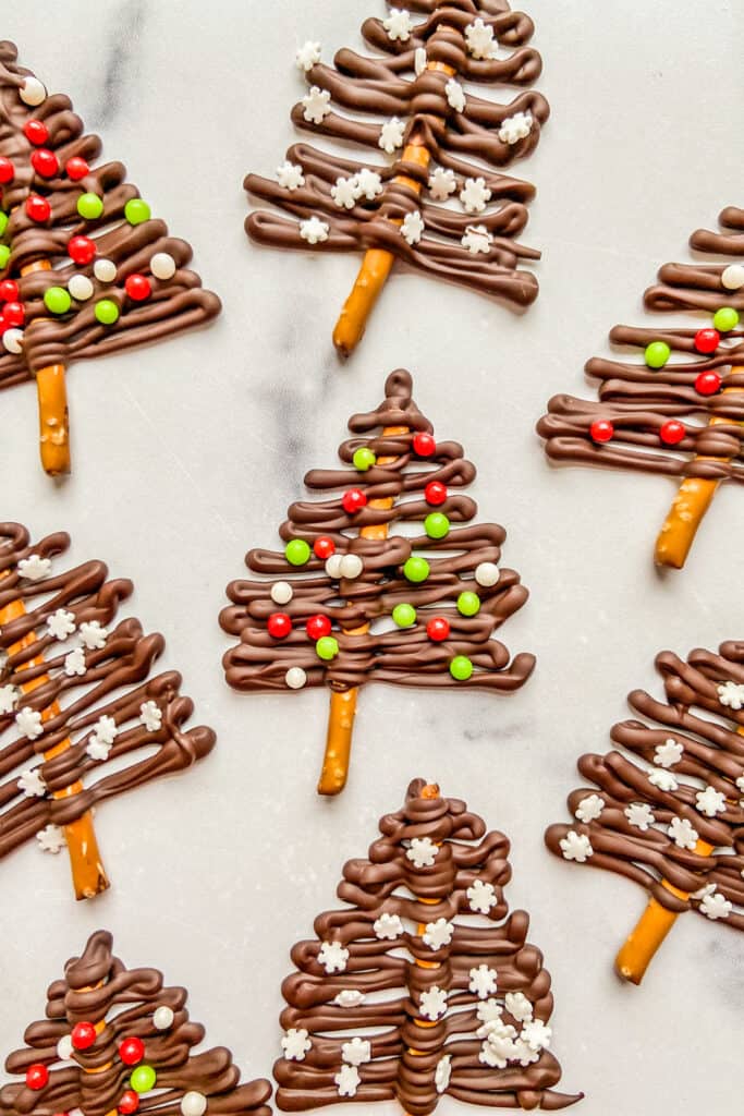An overhead shot of dark chocolate and pretzel Christmas trees.