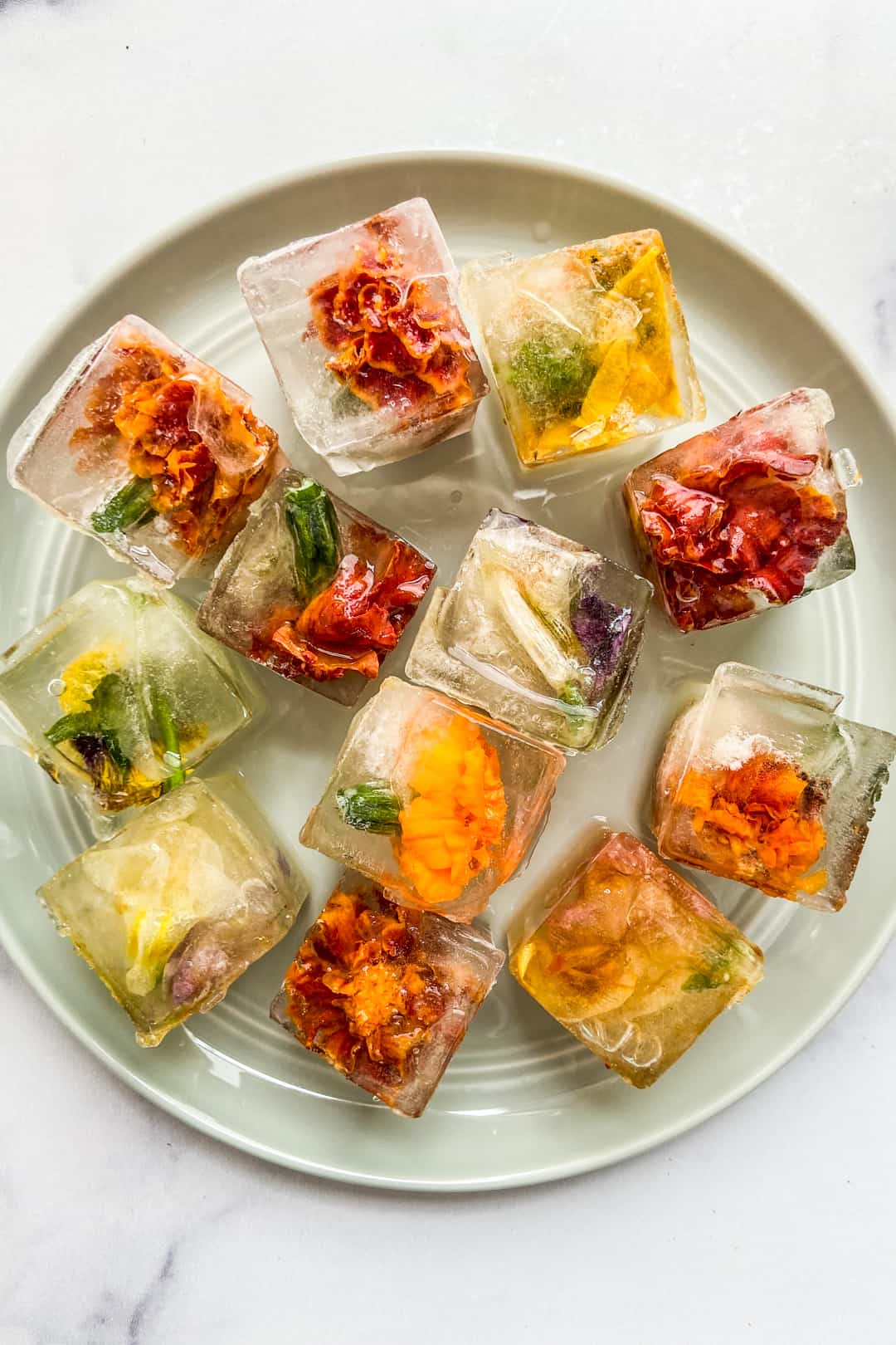 https://thishealthytable.com/wp-content/uploads/2021/11/edible-flower-ice-cubes.jpg