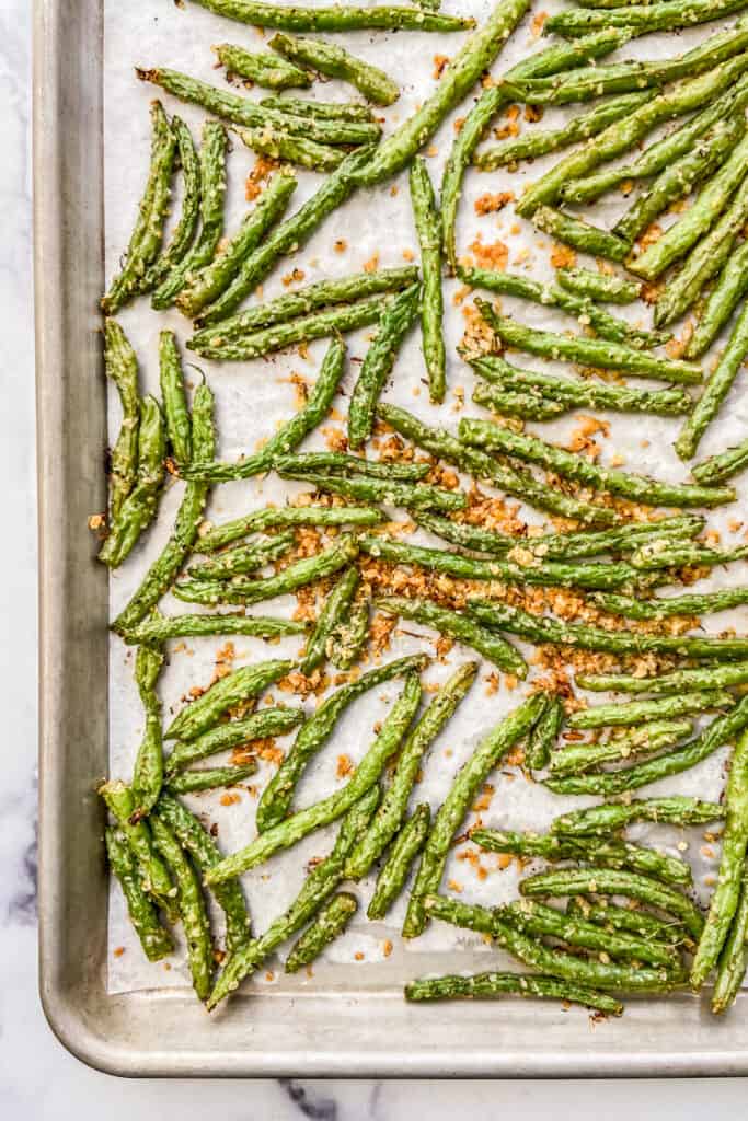 A baking sheet with roasted parmesan green beans.