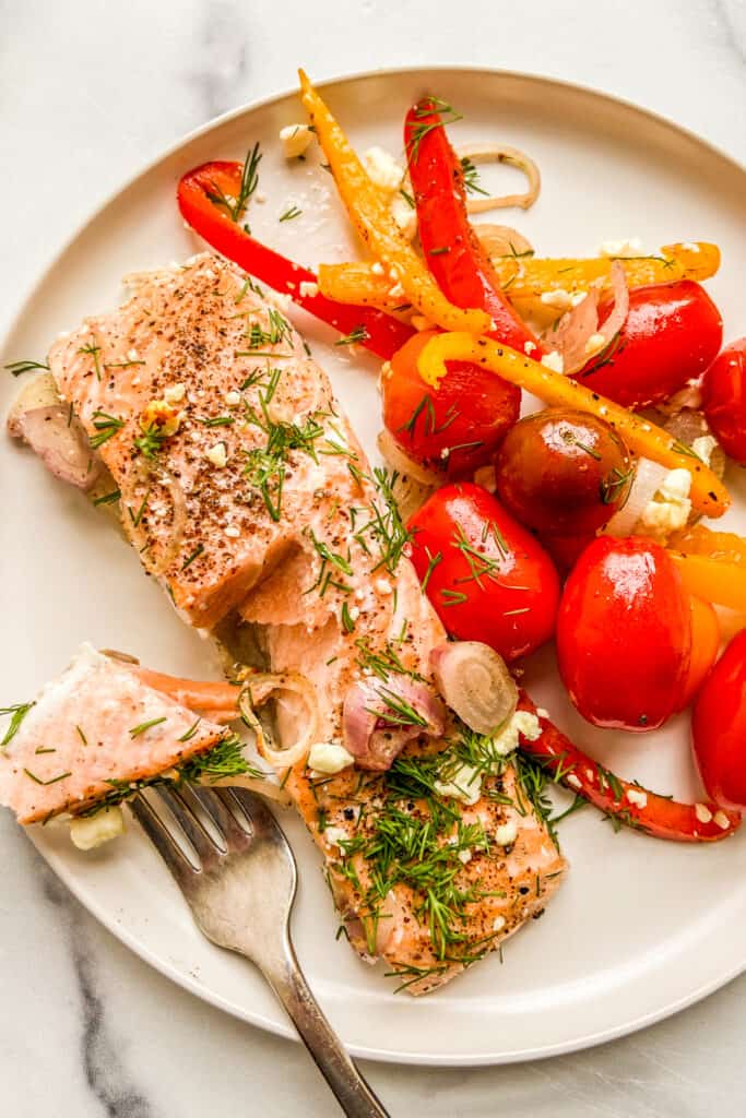 Mediterranean salmon on a white plate with a fork.