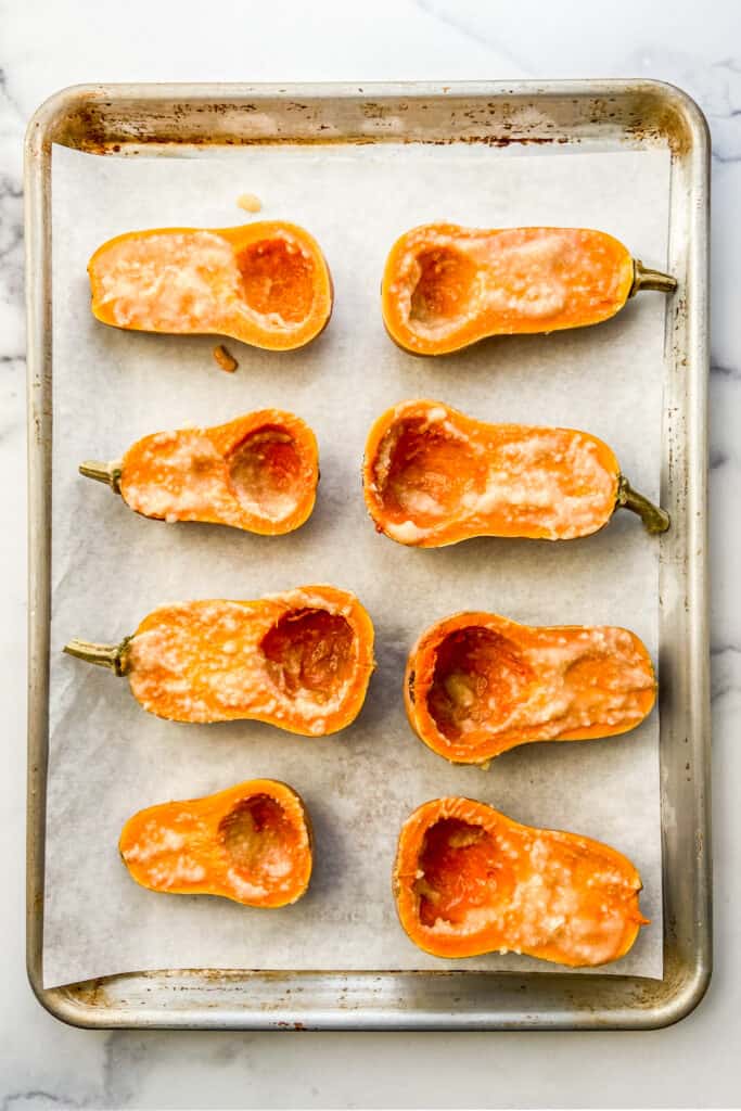 Miso topped honeynut squash on a baking sheet.