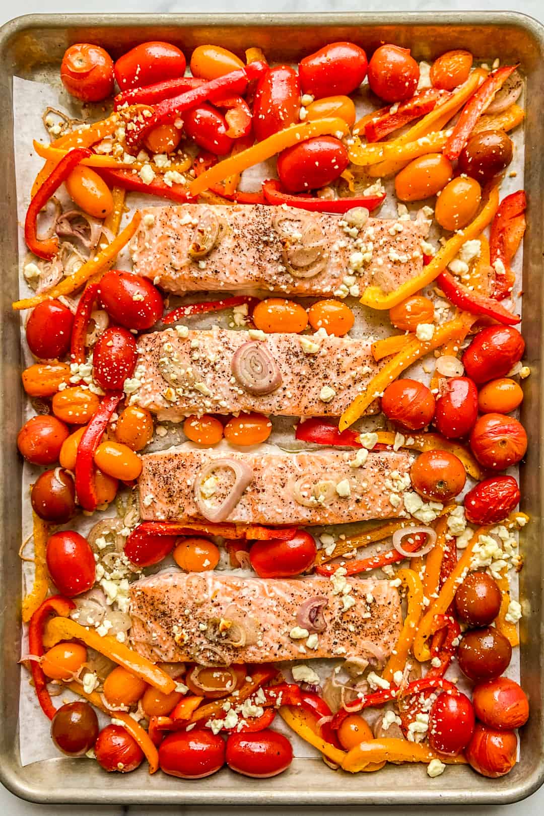 Baked salmon and veggies on a sheet pan.