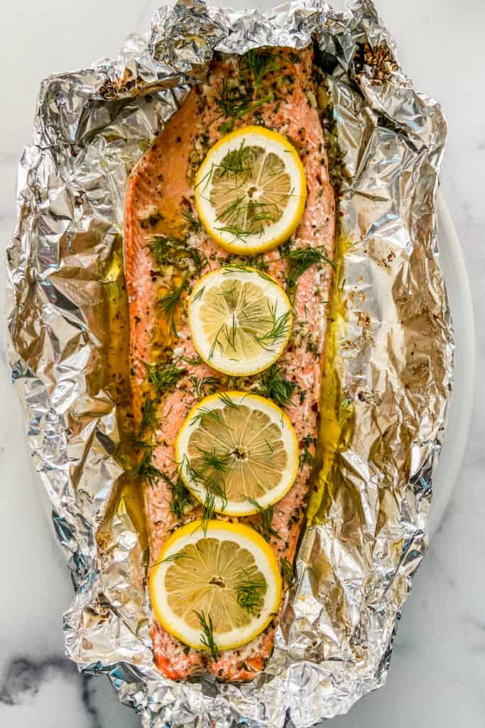 Baked sockeye salmon in foil, topped with lemon slices.