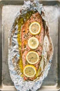 Sockeye salmon in foil with sliced lemons.