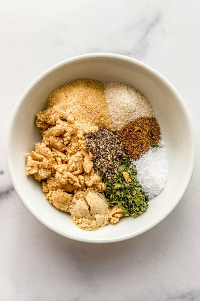 Spices for ramen seasoning in a small white bowl.