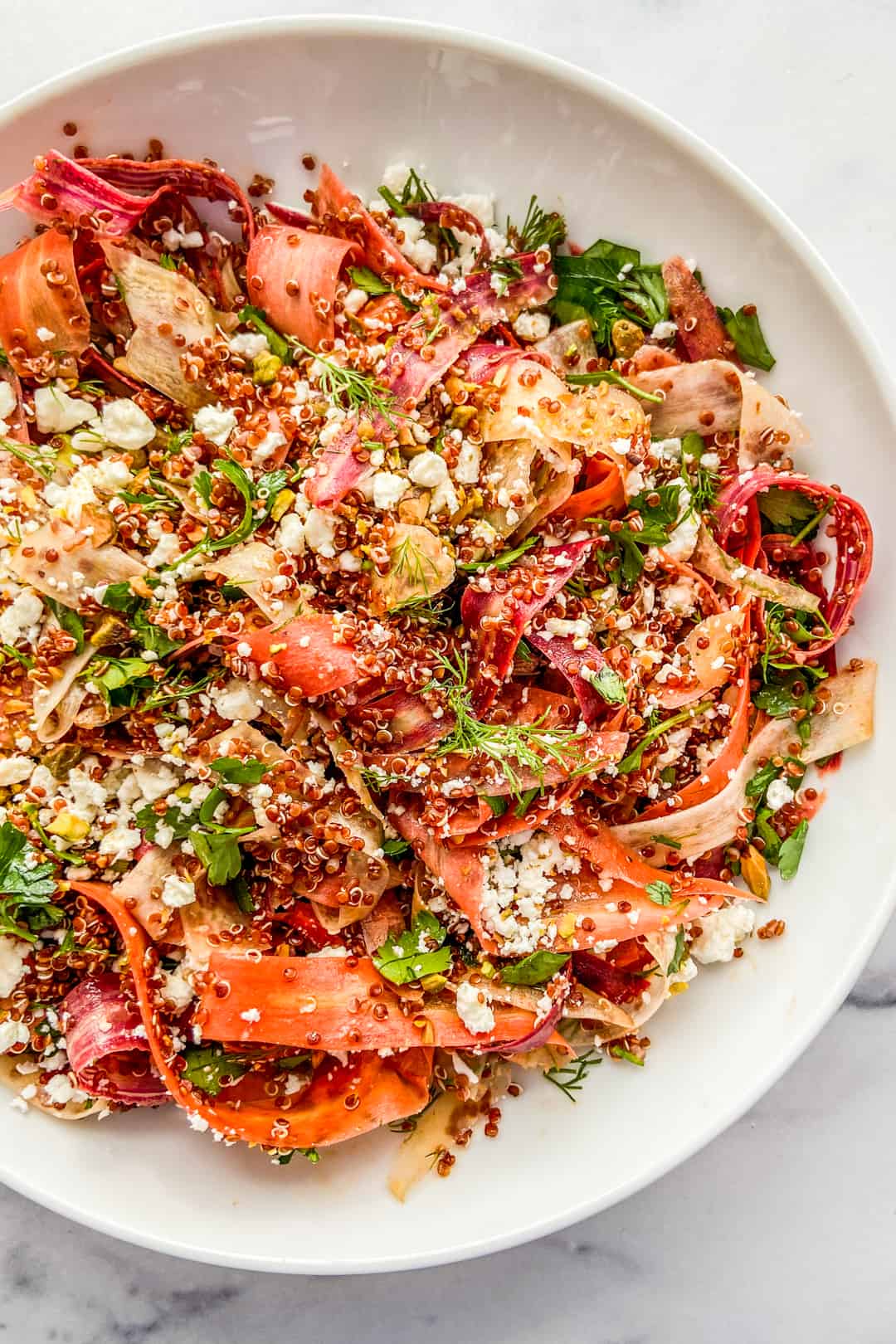 A closeup shot of a rainbow carrot salad.