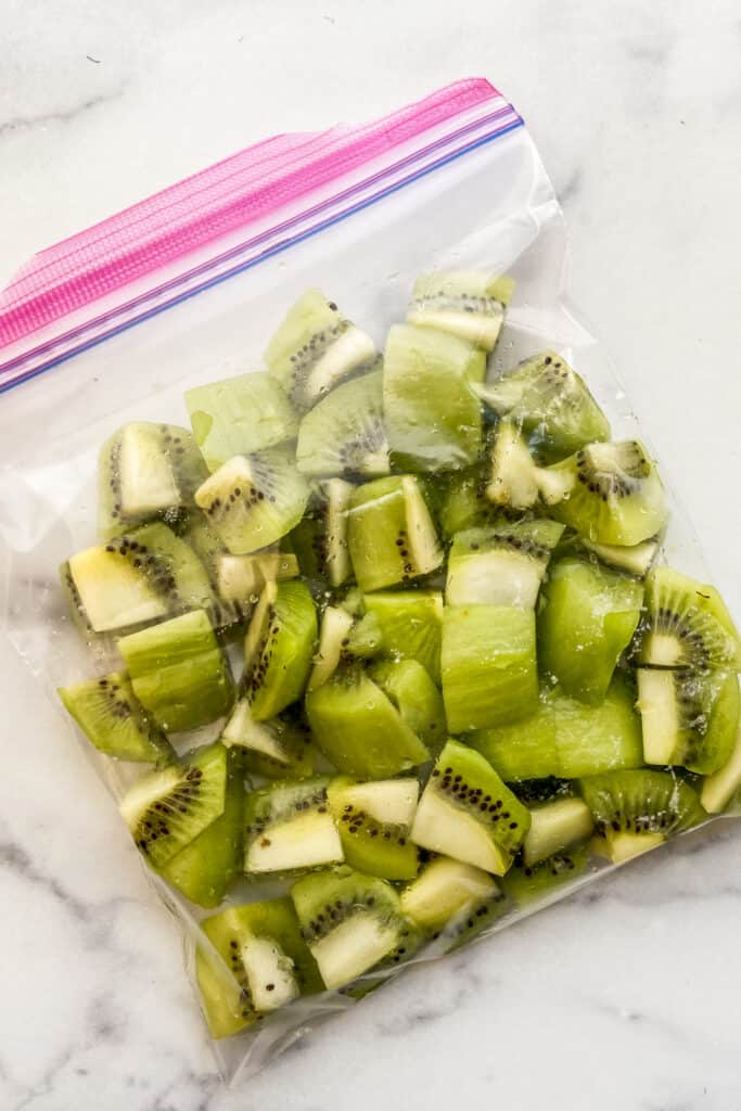 Chunks of kiwi in a plastic bag before going in the freezer.