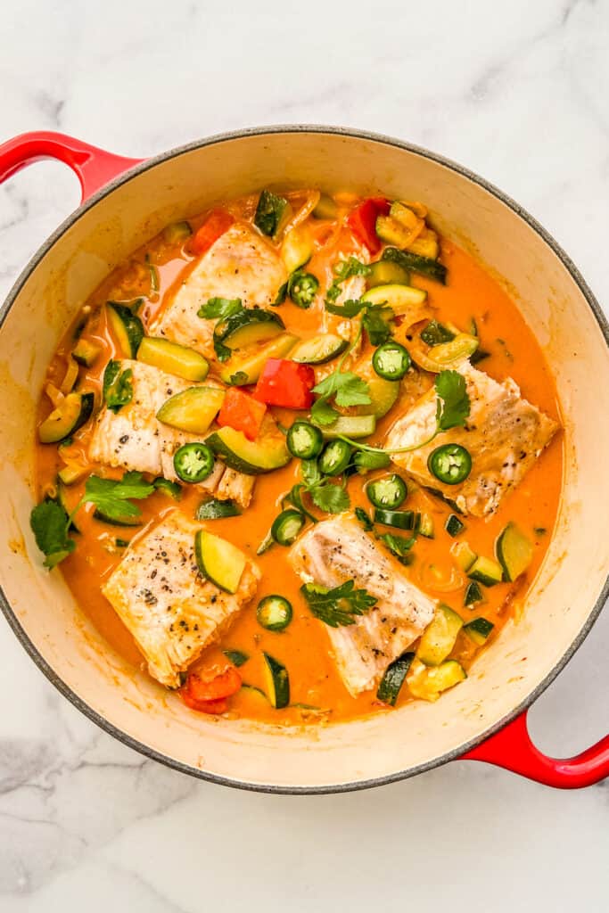 Thai fish curry in a red dutch oven.