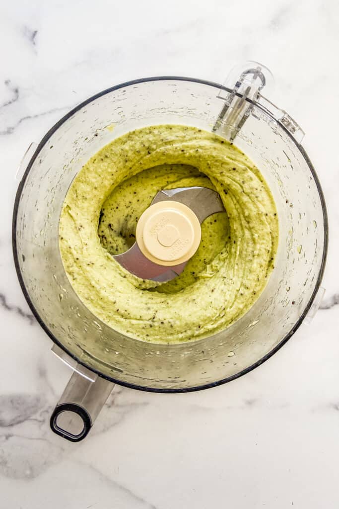 Blended kiwi sorbet in a food processor.