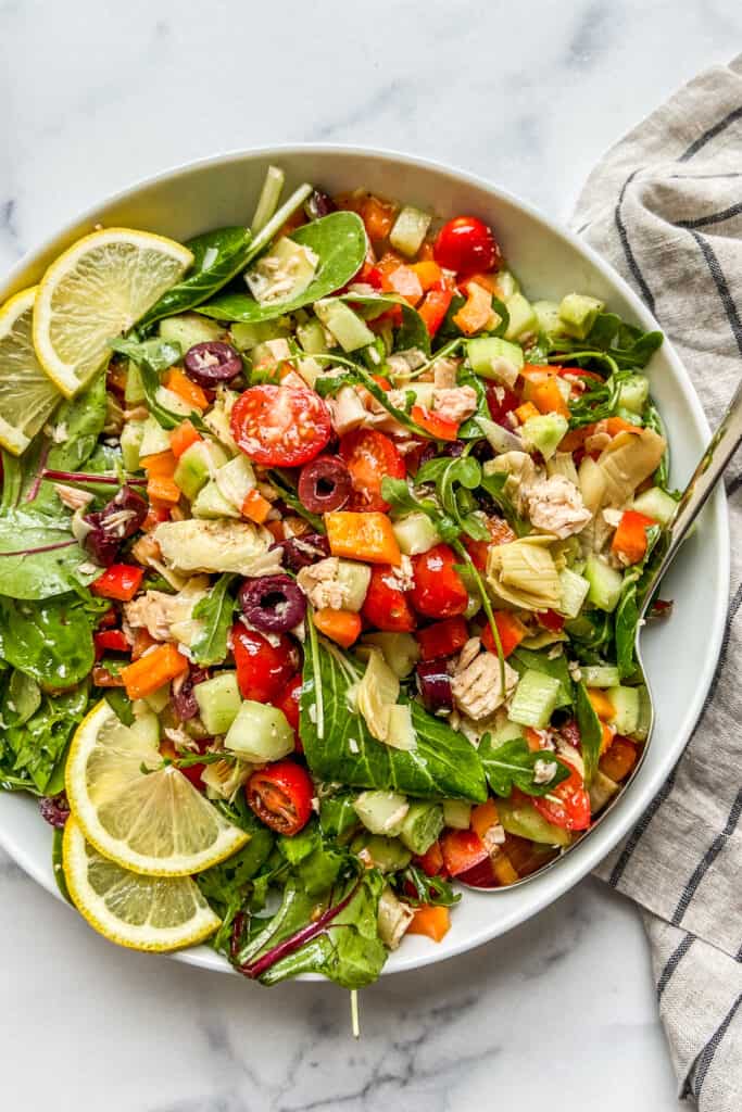 A large Mediterranean tuna salad in a white serving bowl.