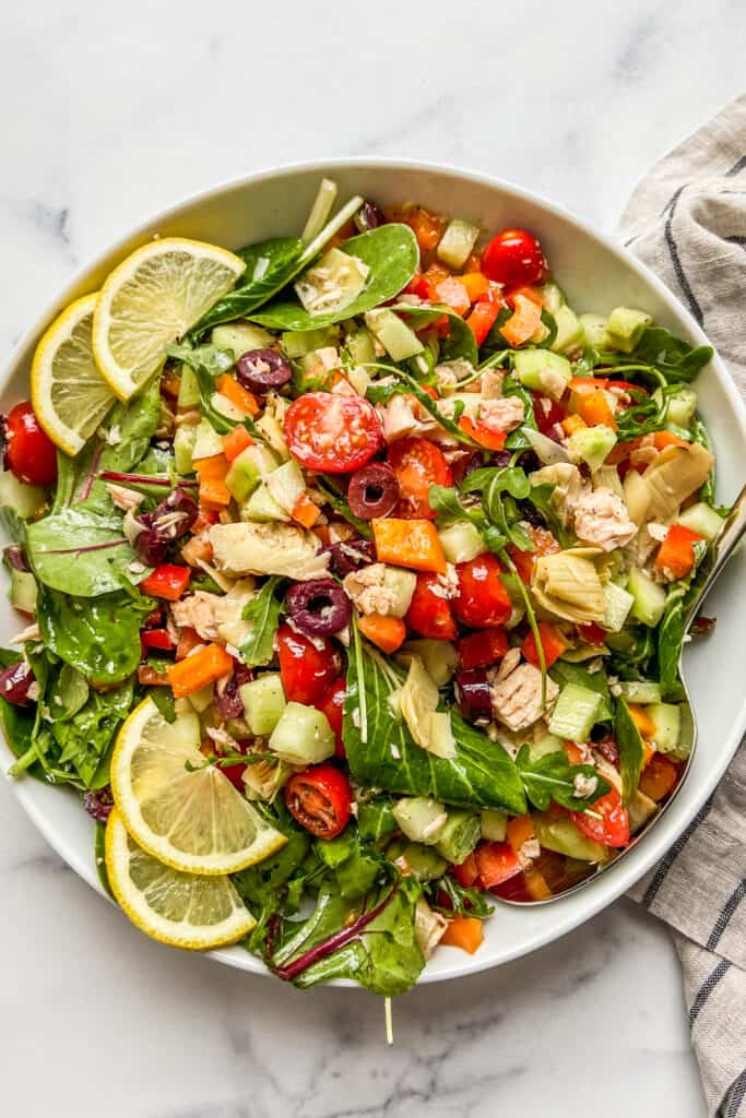 A Mediterranean tuna salad in a large white serving bowl.