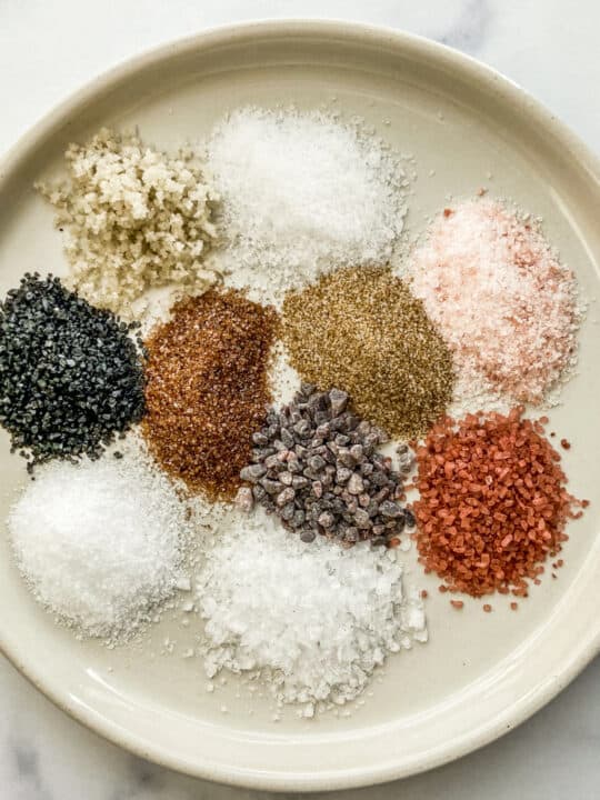 Ten types of salt on a white plate.