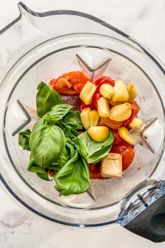 Roasted tomatoes, garlic, basil, and a stock cube in a blender.