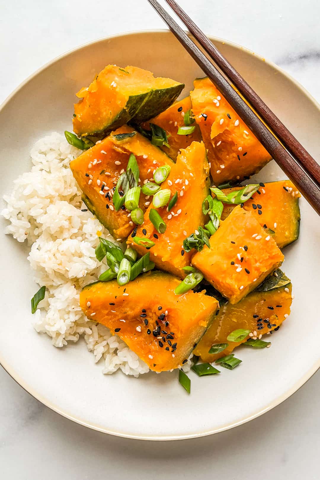 Kabocha squash pieces with rice in a bowl.