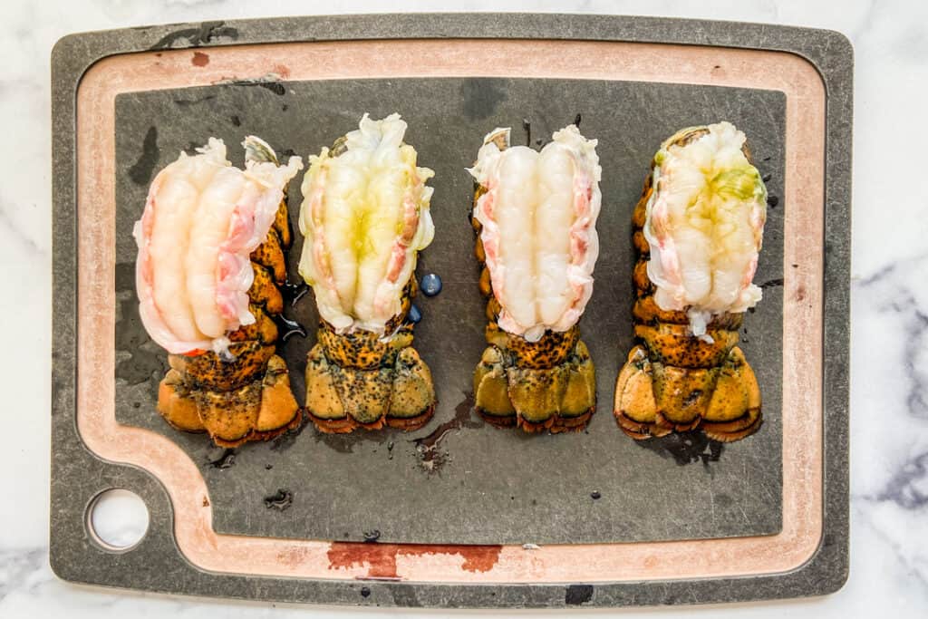 Four lobster tails, cut down the shell with the flesh sitting on top of the shell.