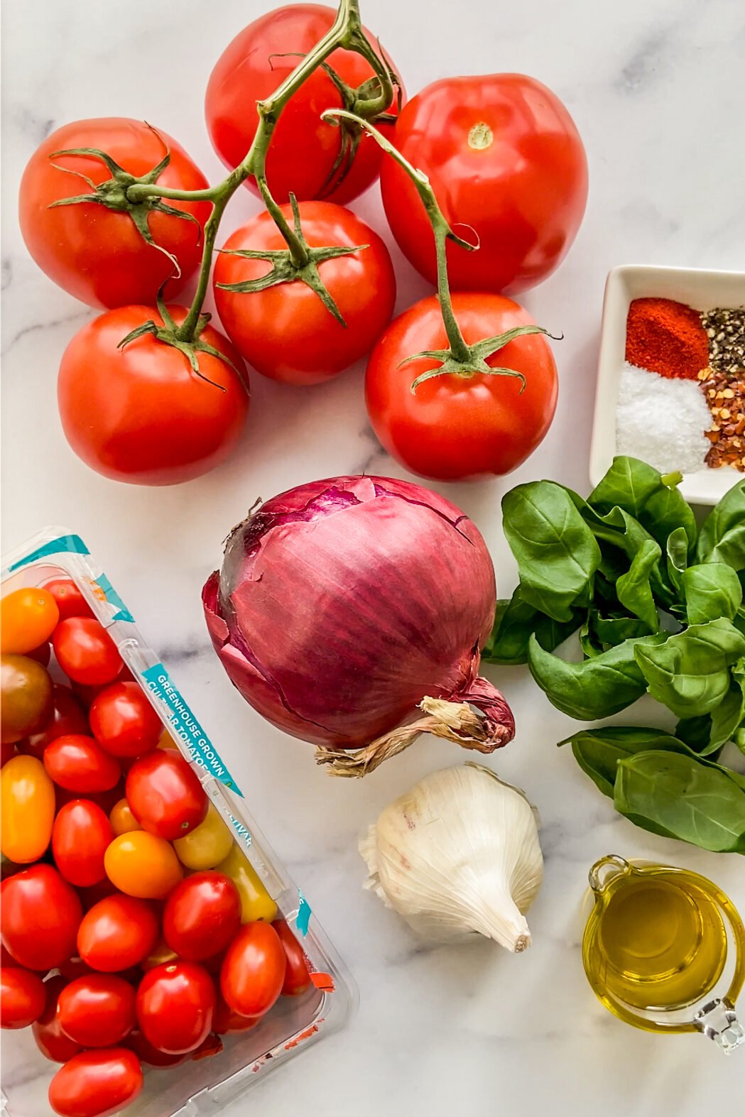 Tomatoes, red onion, basil, spices, cherry tomatoes, garlic, and olive oil.