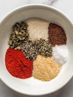 Cajun seasoning spice blend in a small white bowl.