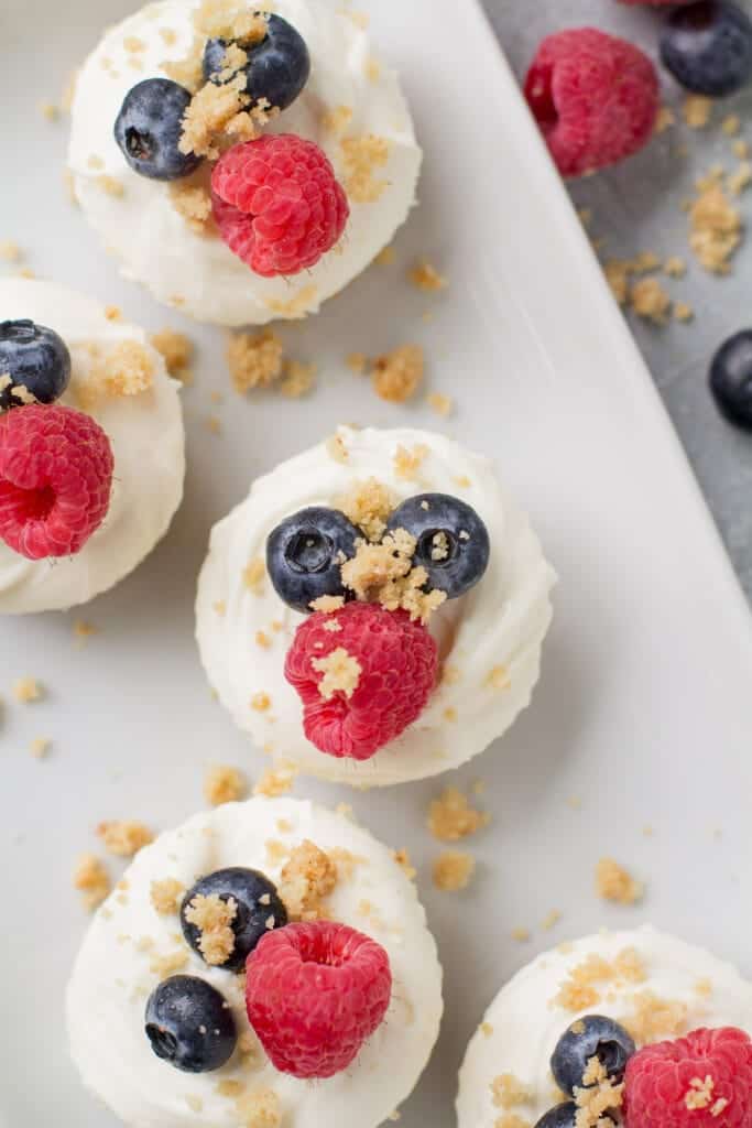 Healthy cheesecakes bites topped with berries.