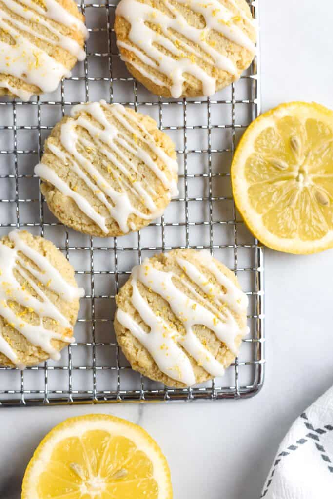 Lemon cookies with a sugar drizzle on a cooling rack.