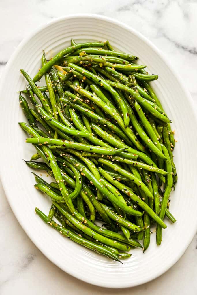 Asian green beans on a large white serving platter.