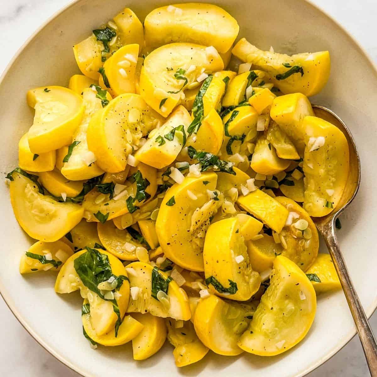 Easy sauteed summer squash in a white serving bowl.