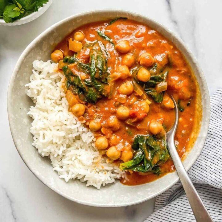 Chickpea spinach curry in a bowl with rice.