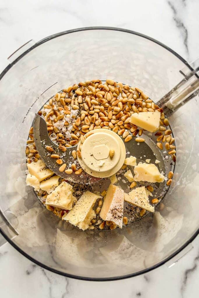Pine nuts, parmesan, salt, and pepper in a food processor.