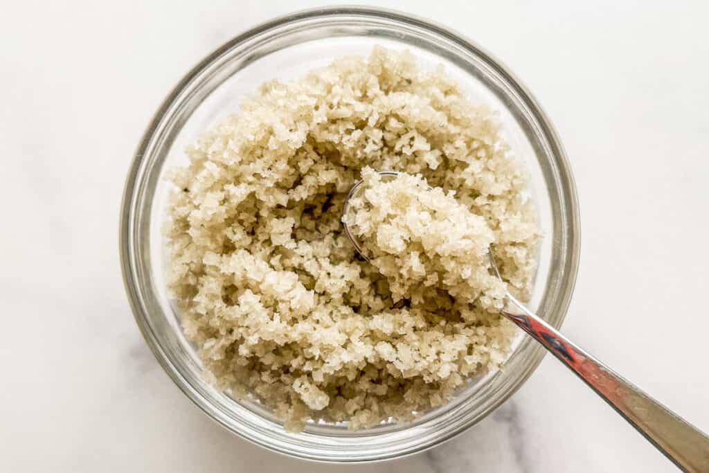 Sel gris in a small glass bowl with a spoon.