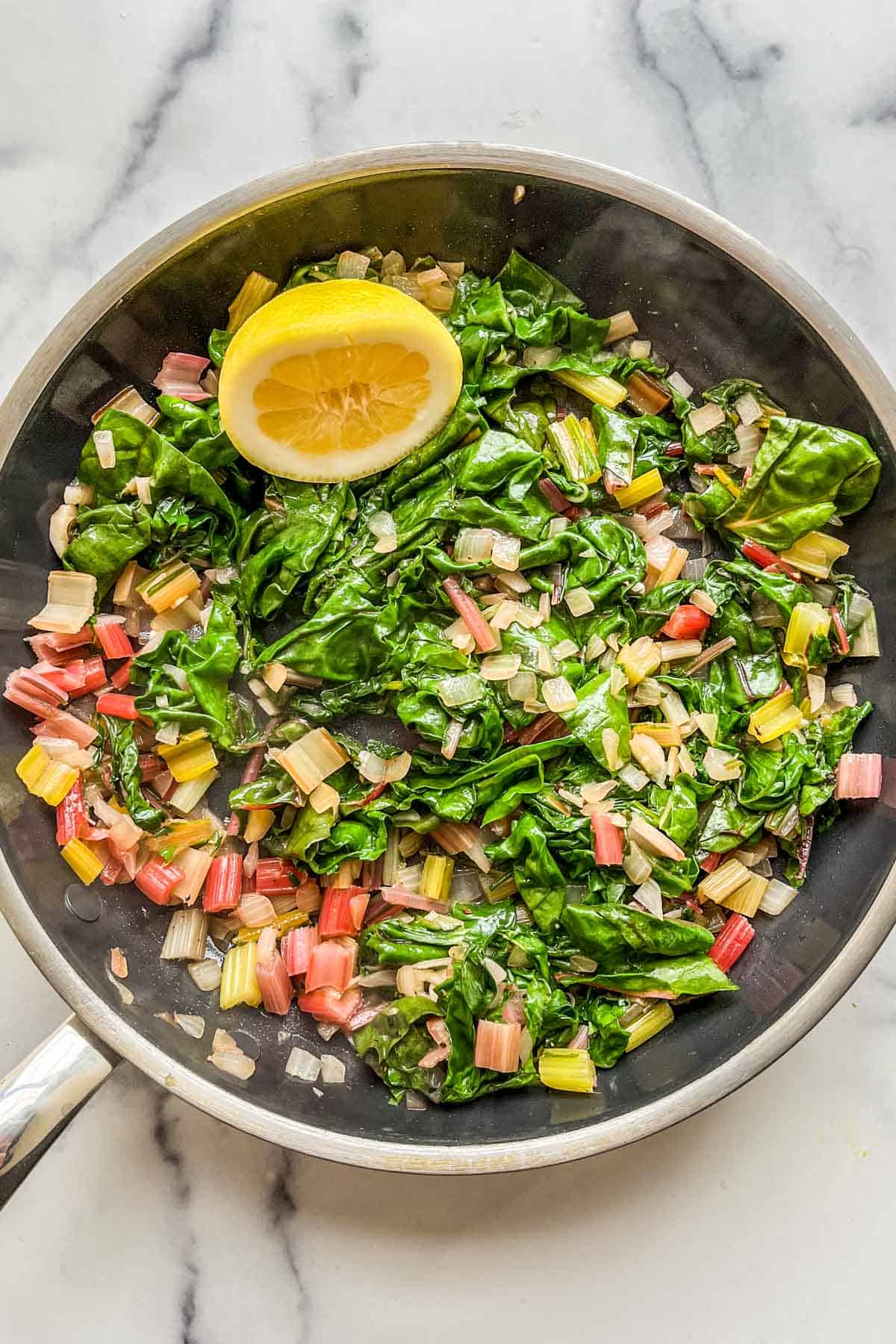 Sauteed rainbow swiss chard in a large skillet.