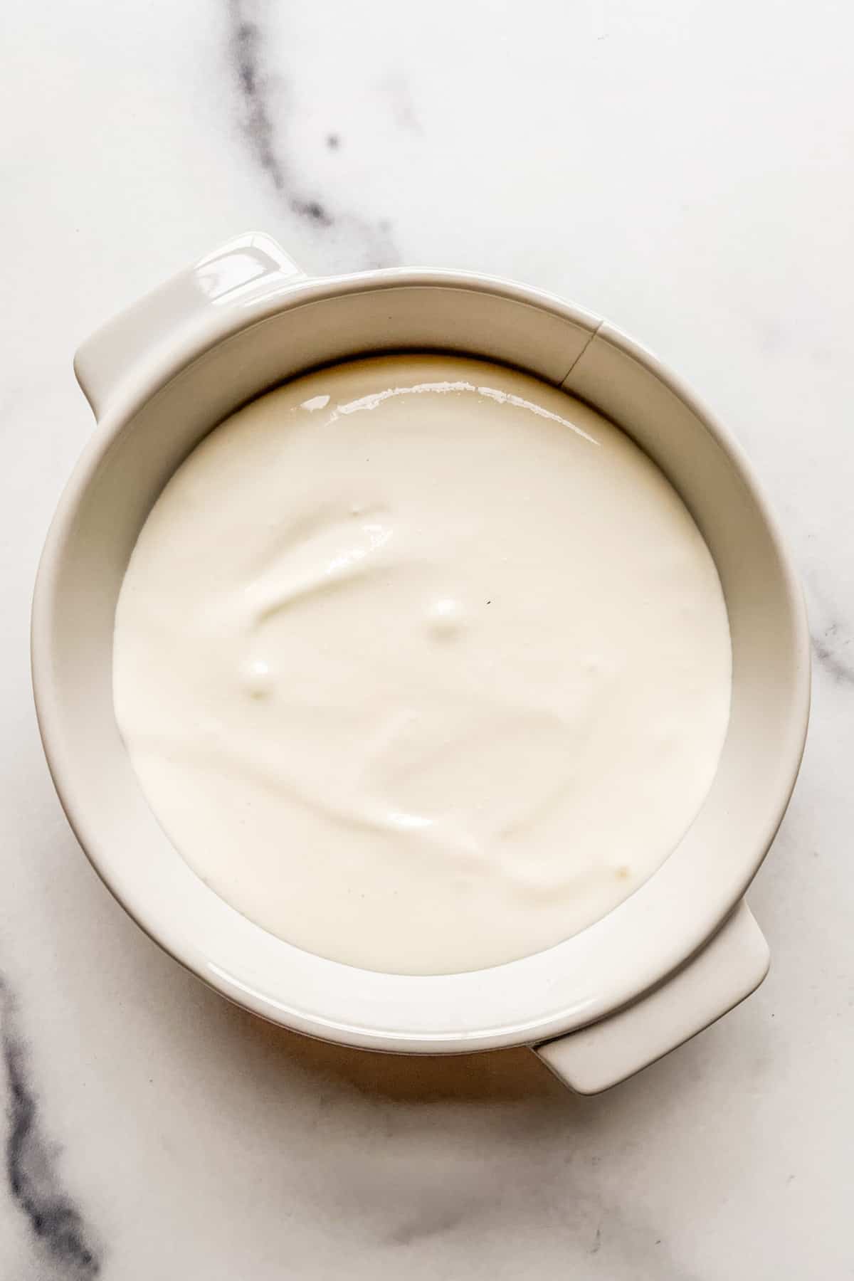 Blended cottage cheese in a white ramekin.