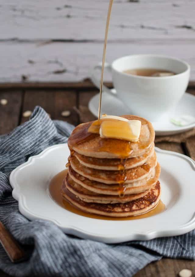 Almond flour pancakes in a stack with syrup.