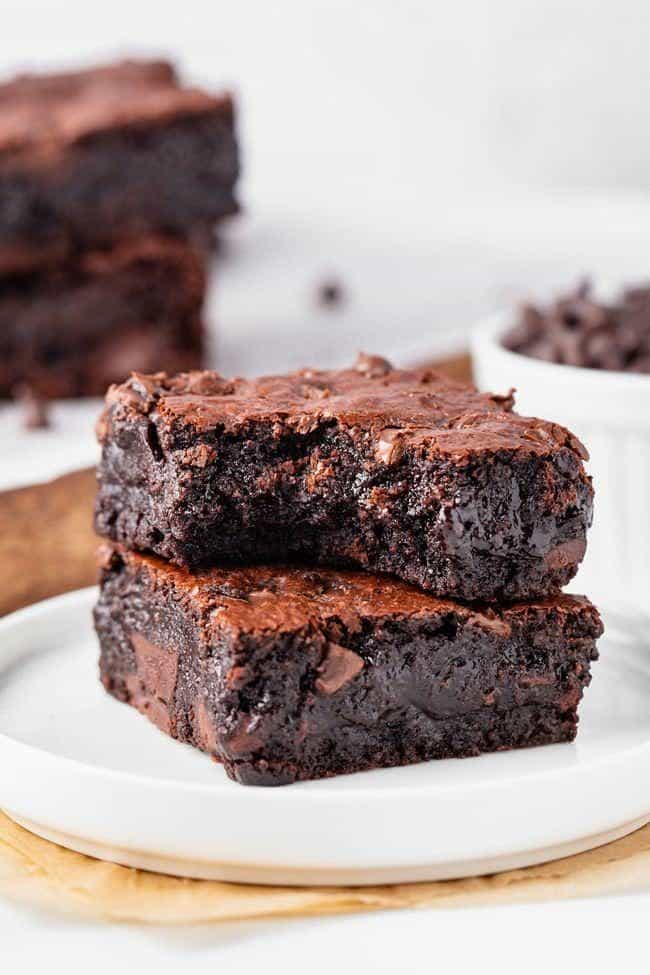 Almond flour brownies stacked on a plate.