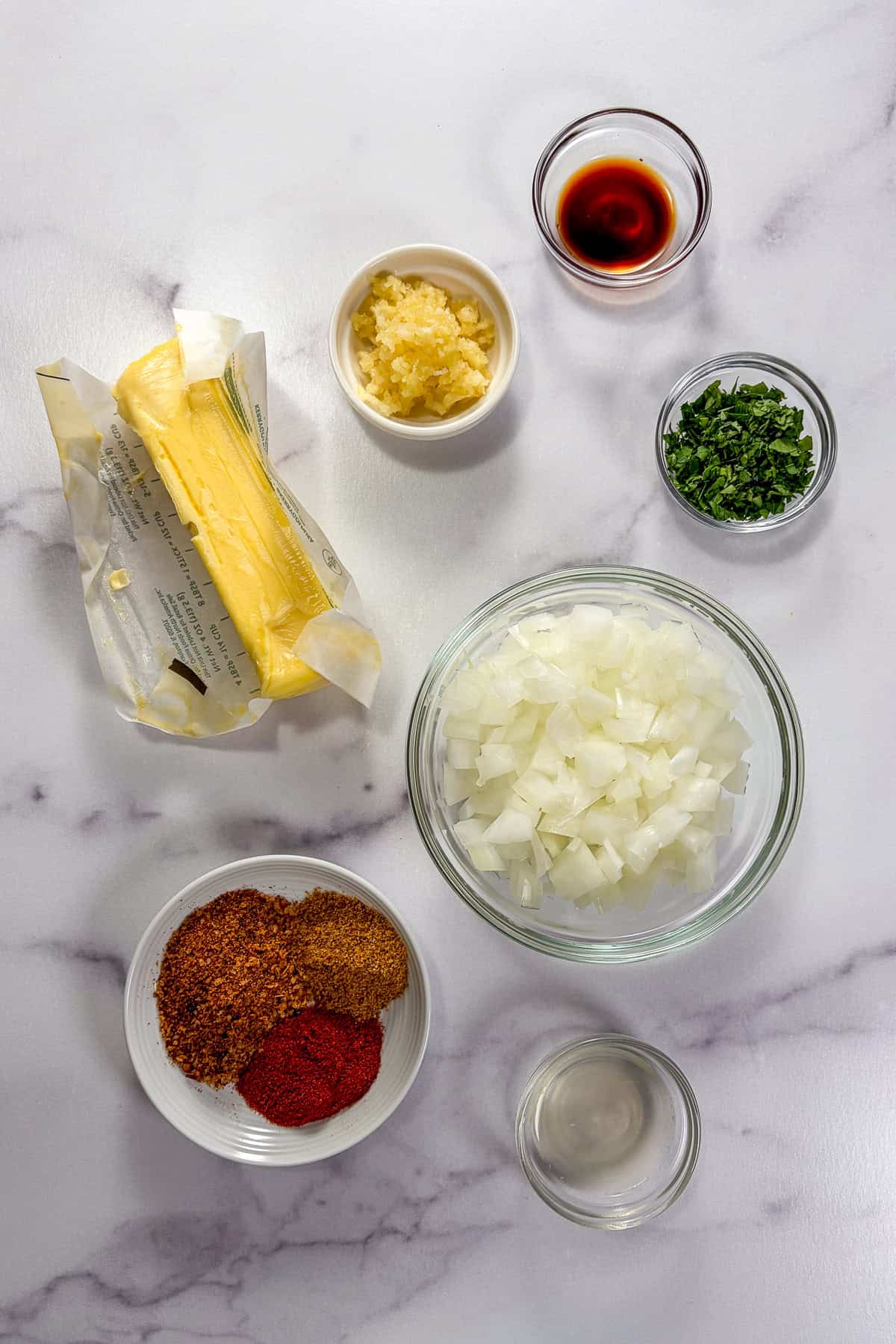 Ingredients for cajun butter seafood boil sauce on a marble background.