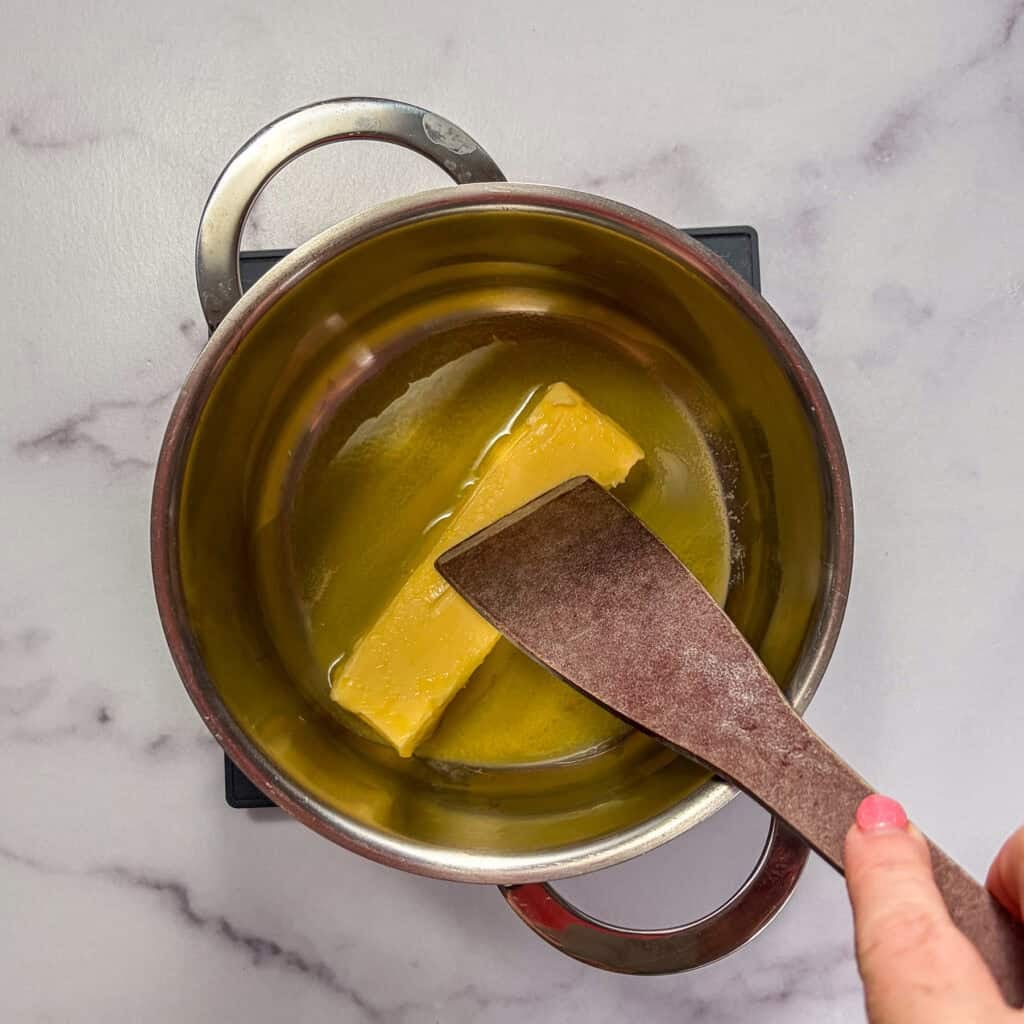 Melting butter in a small sauce pan.