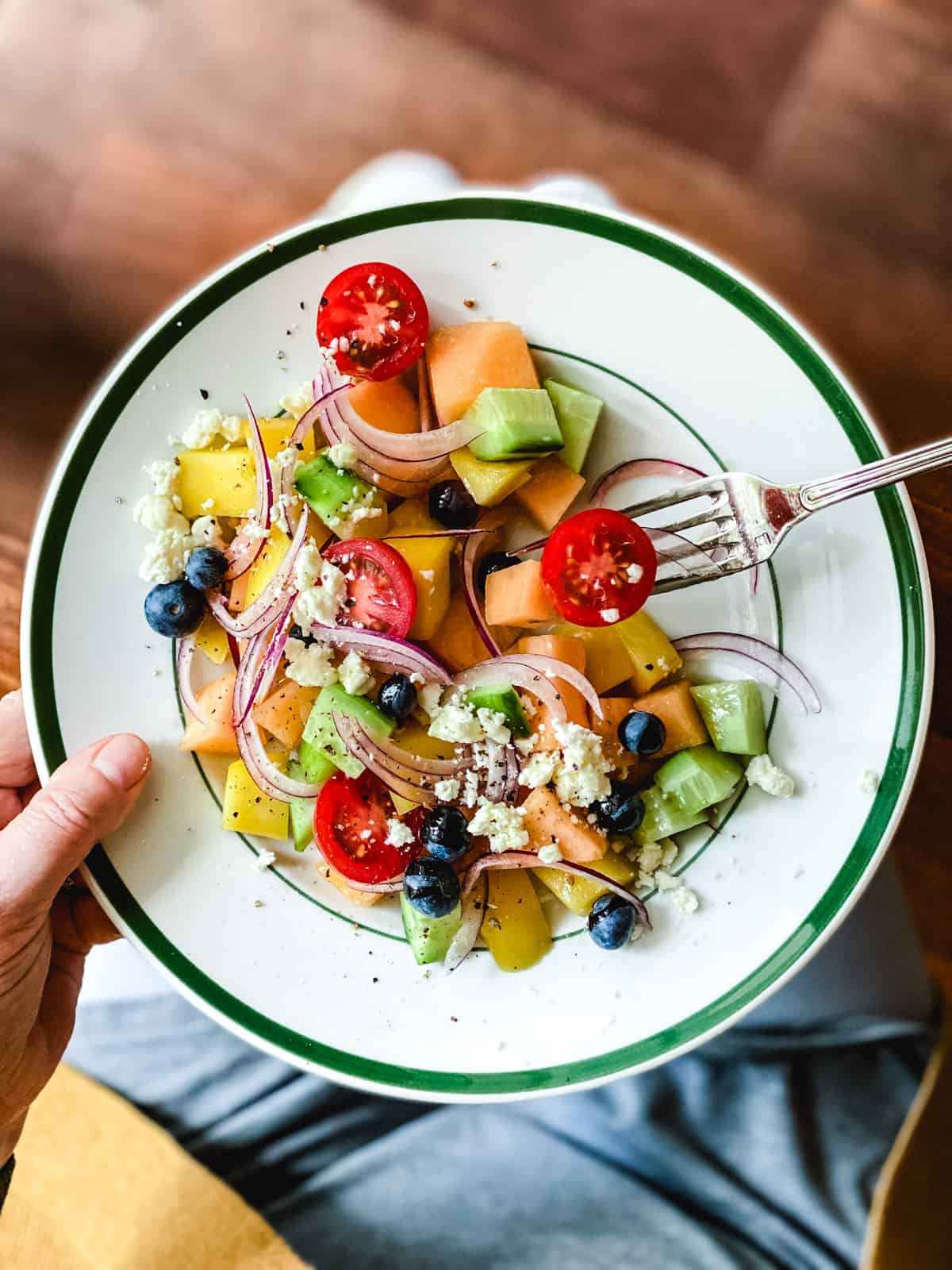 Cantaloupe mango salad on a white plate.