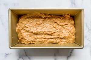 Cantaloupe bread batter in a bread pan before going in the oven.
