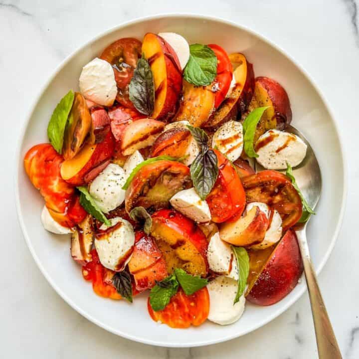 A fresh tomato salad in a white bowl.