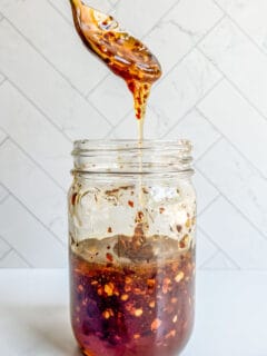 Hot honey in a jar with a gold spoon.