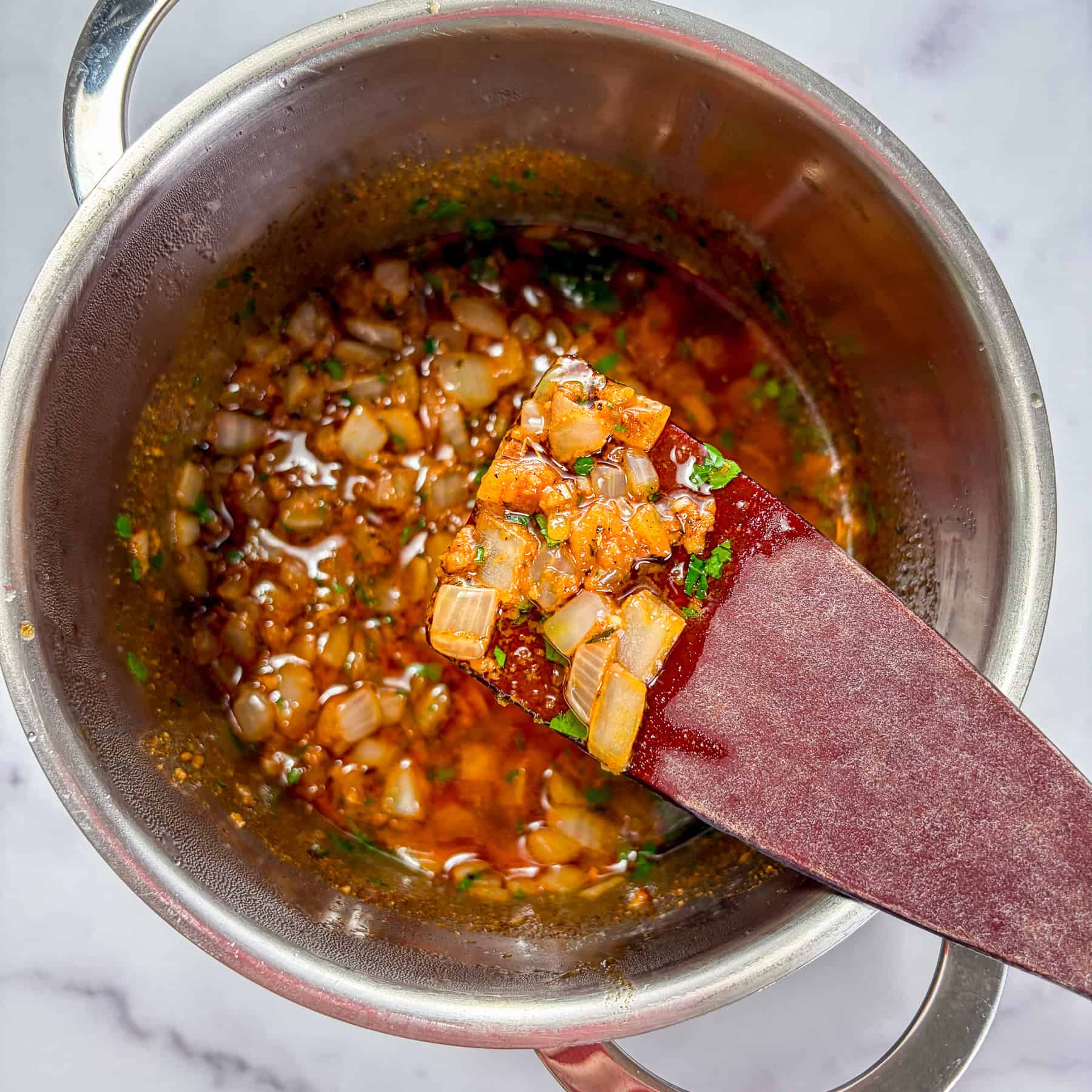 Shrimp boil sauce in a small sauce pan.