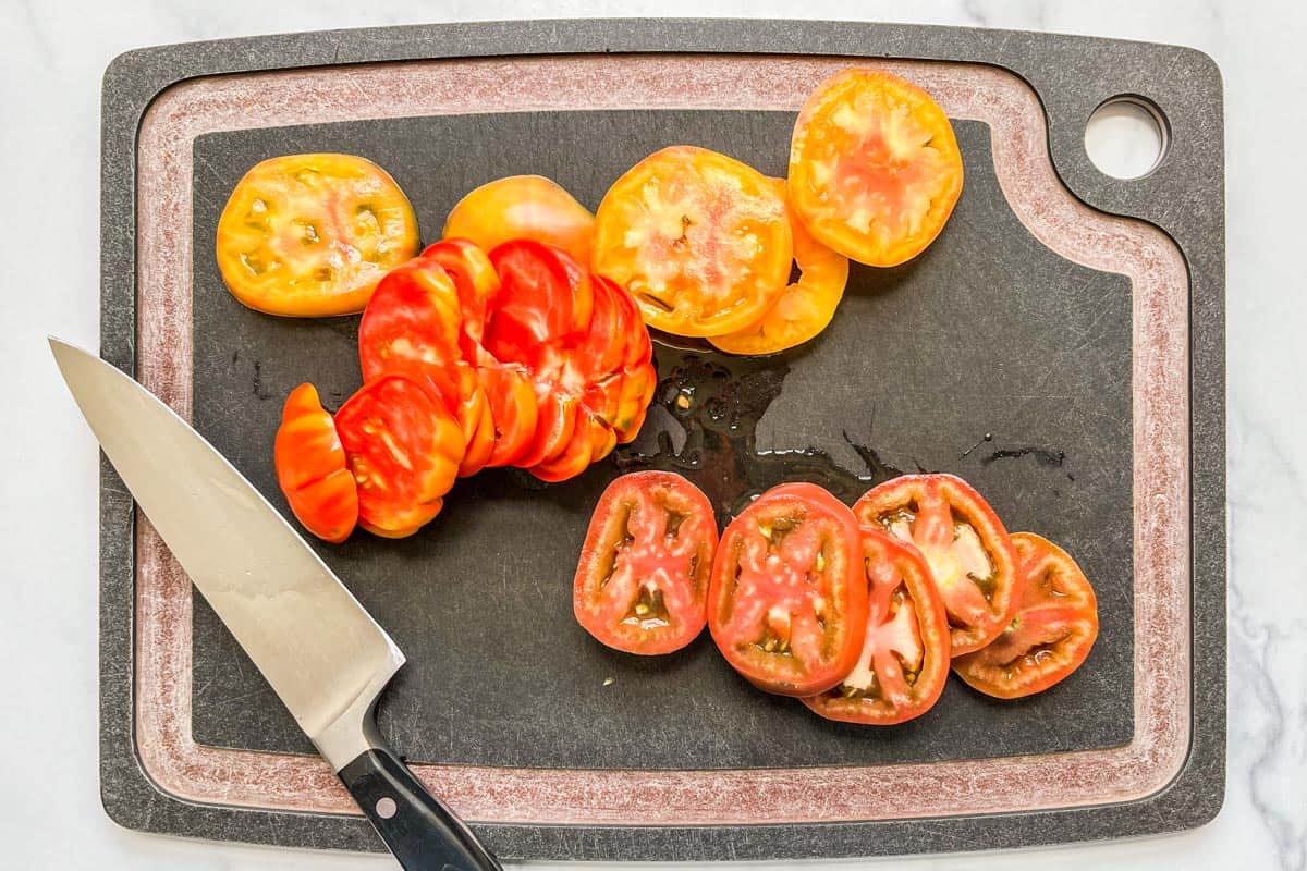 Sliced heirloom tomatoes on a cutting board.