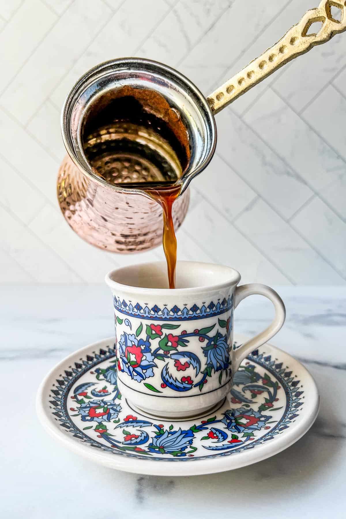 Turkish coffee being poured into a cup.