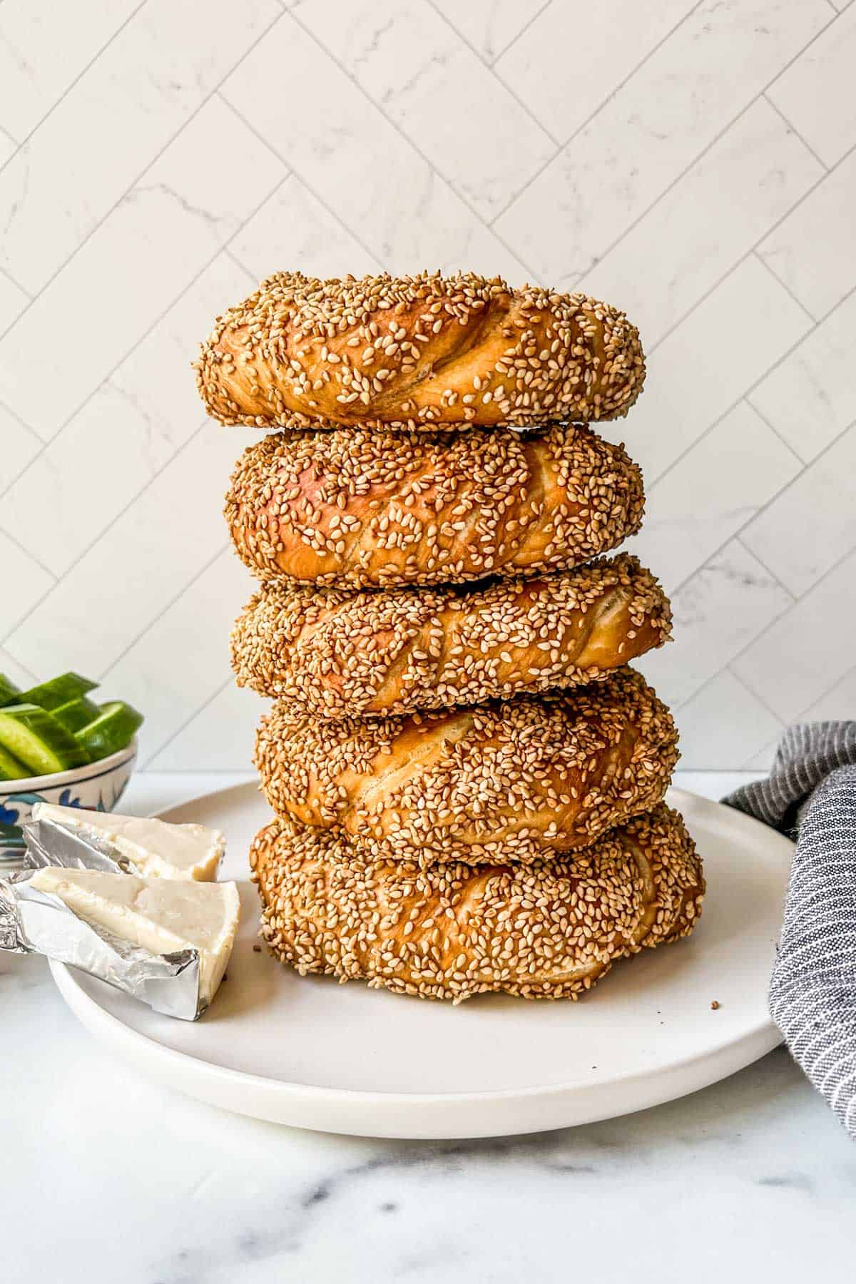 A stack of simit on a white plate.