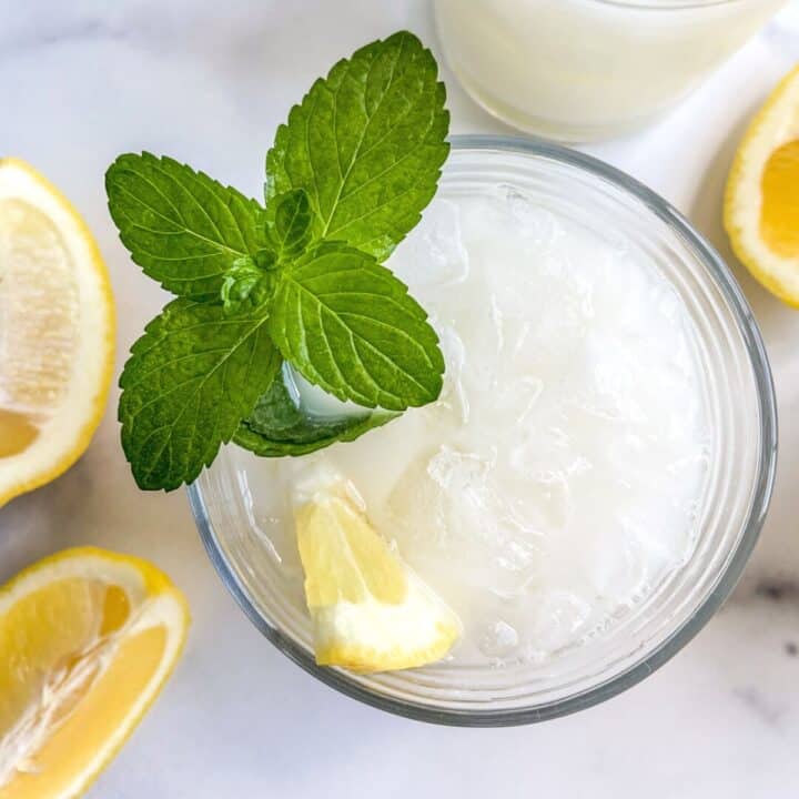 Creamy lemonade in a glass with mint and a lemon slice.