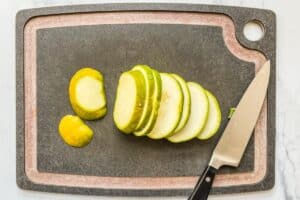 Sliced patty pan squash on a cutting board.